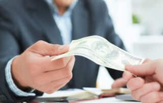 Client handing money to an adviser/ planner