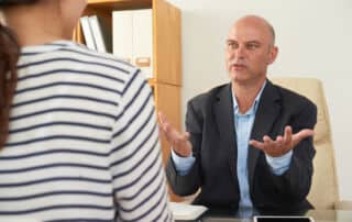 Financial planner looking confused by the behaviour of his client.