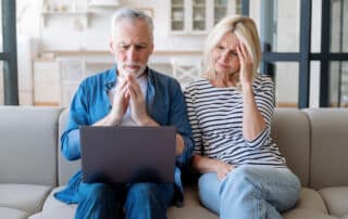 Puzzled couple tring to fill in an online risk questionnaire