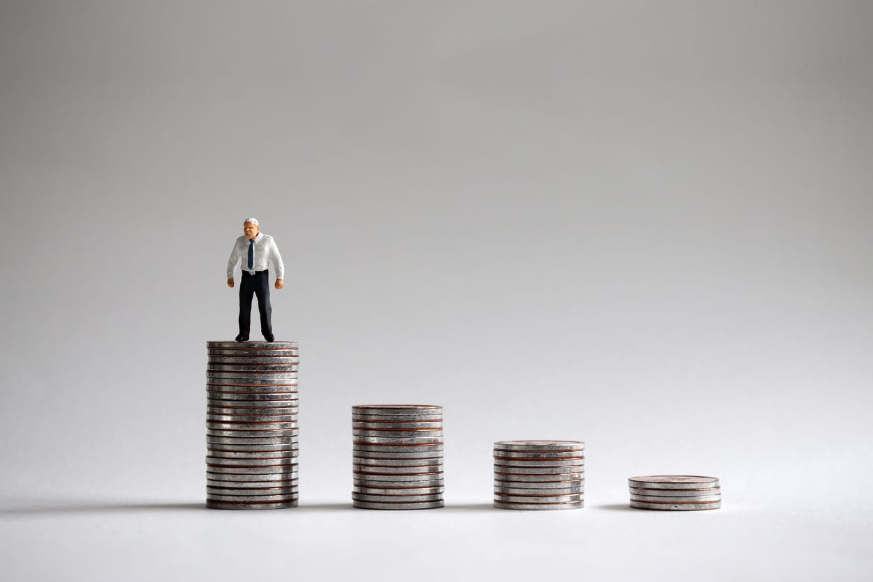 Mans standing on a pile of coins